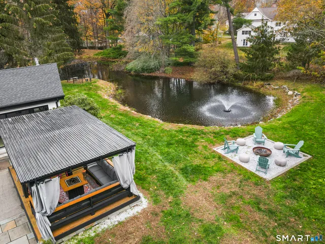 an aerial view of a house with garden space and lake view