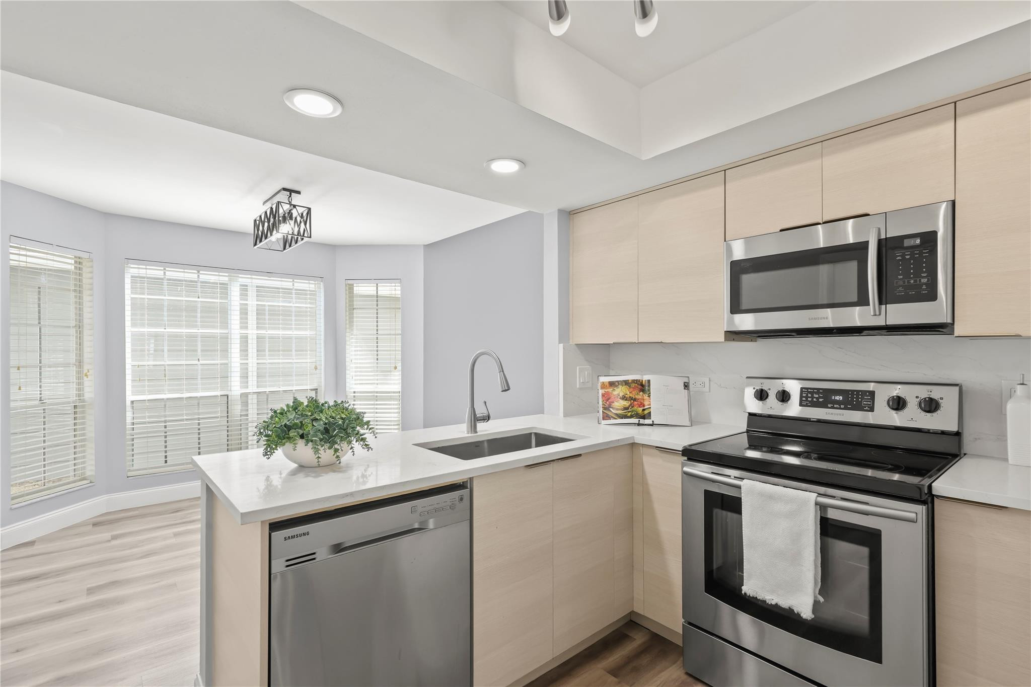 5339 Park Pl Circle Boca Raton, FL 33431 - Photo 6 of 46 a kitchen with stainless steel appliances a stove a sink and a microwave