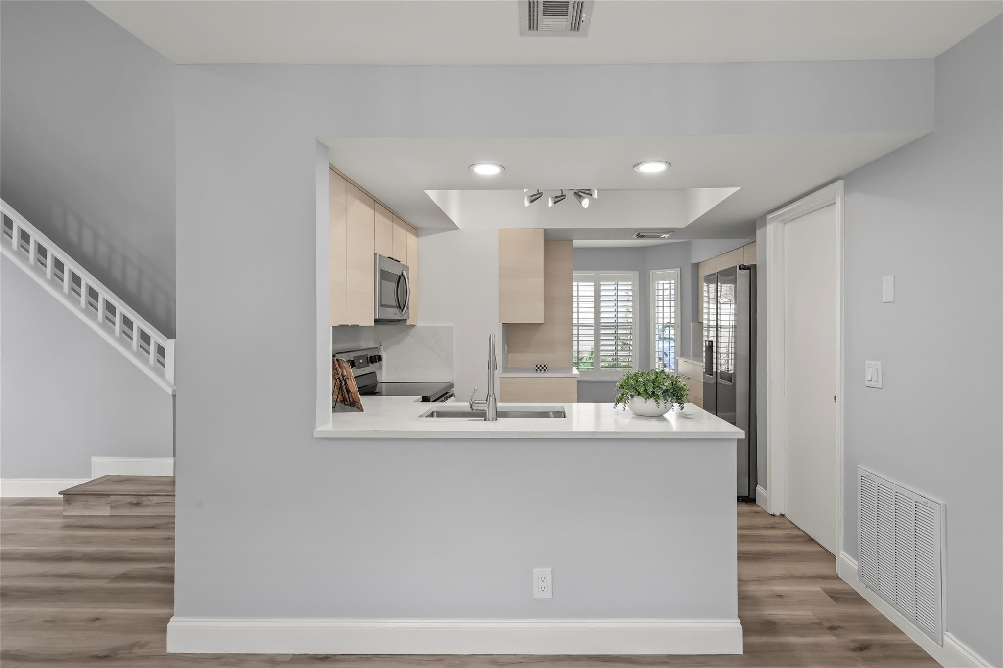 5339 Park Pl Circle Boca Raton, FL 33431 - Photo 10 of 46 a dining hall with stainless steel appliances granite countertop a sink and dishwasher with wooden floor