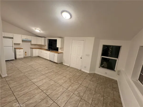 a view of a kitchen with refrigerator and microwave