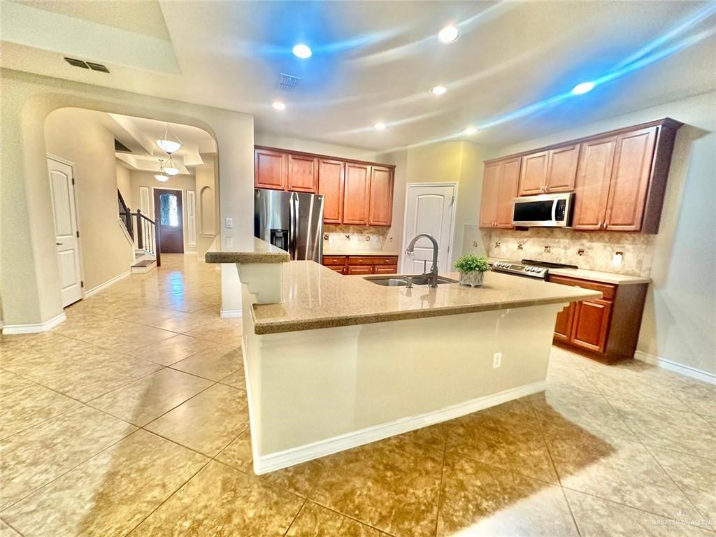 3900 Santa Maria Street Mission, TX 78572 - Photo 2 of 31 a dining hall with stainless steel appliances granite countertop a sink and cabinets