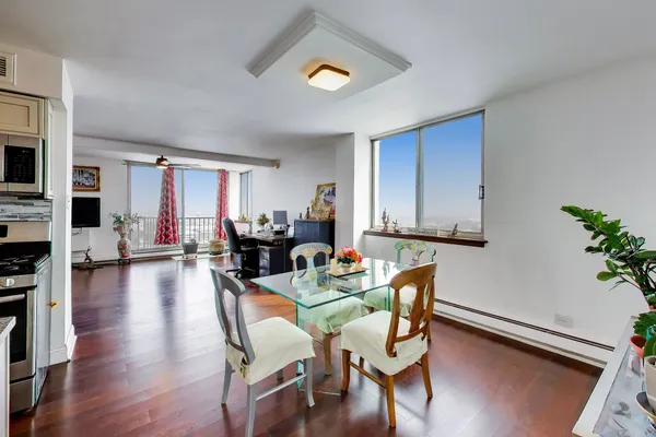 a kitchen with stainless steel appliances white cabinets and a refrigerator
