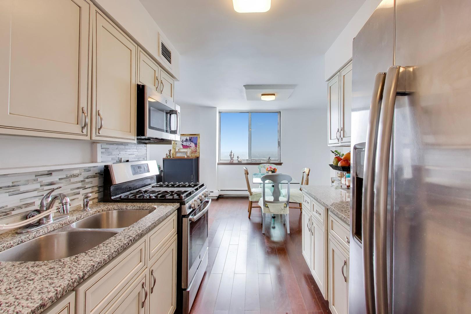 40 North Tower Road, Unit 16N Oak Brook, IL 60523 - Photo 13 of 31 a kitchen with granite countertop a sink stove and refrigerator