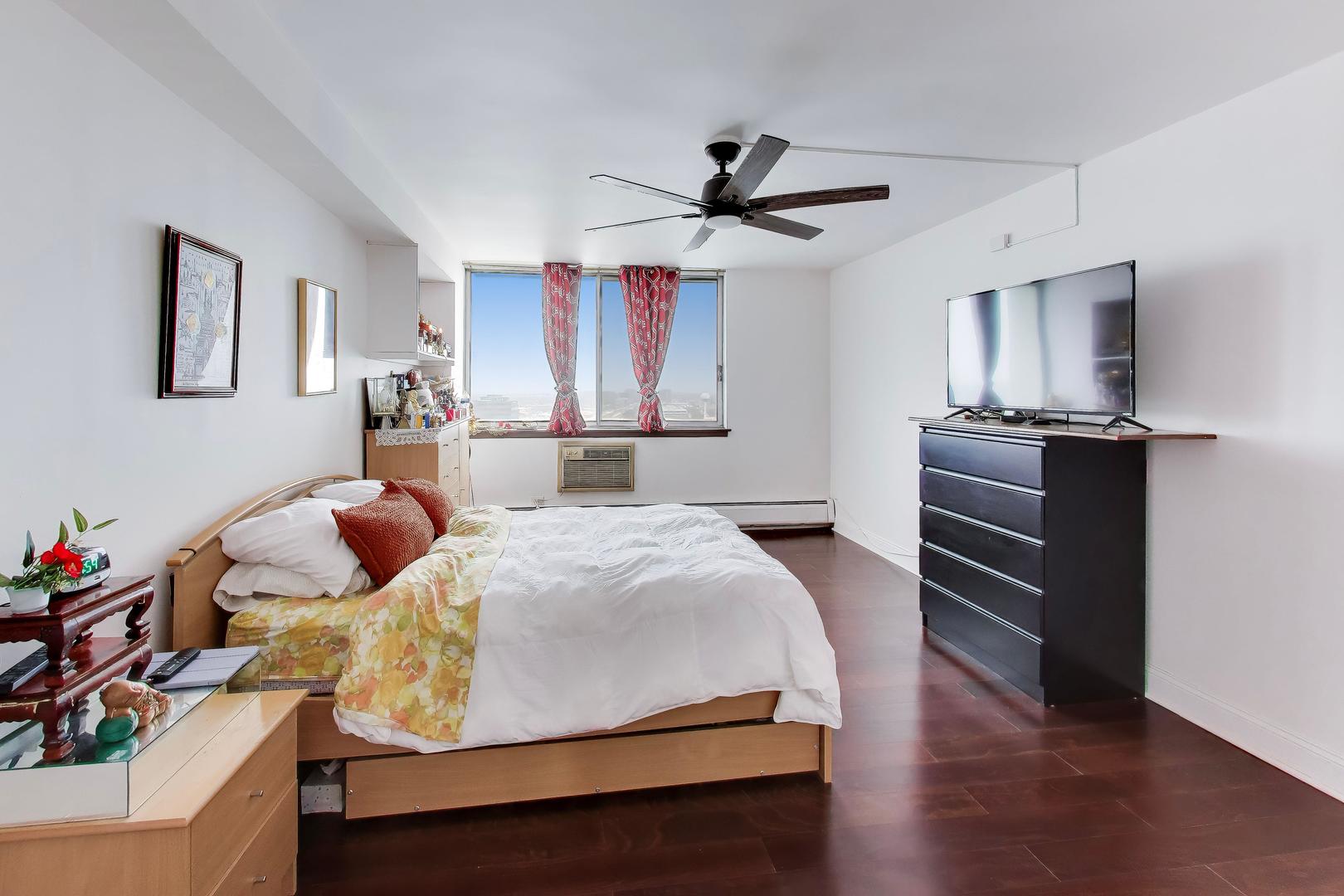 40 North Tower Road, Unit 16N Oak Brook, IL 60523 - Photo 16 of 31 a bedroom with a bed and wooden floor