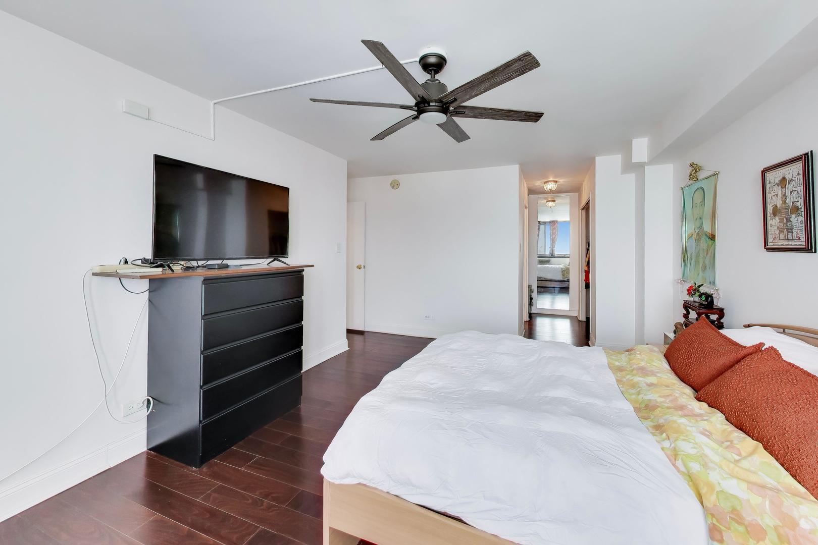 40 North Tower Road, Unit 16N Oak Brook, IL 60523 - Photo 17 of 31 a bedroom with a bed and a flat screen tv