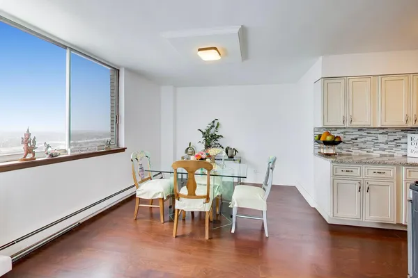a dining room with furniture and wooden floor