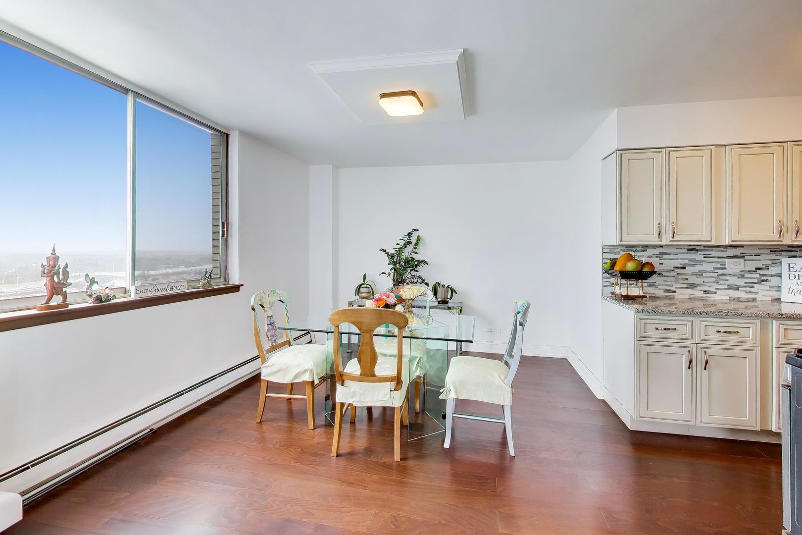 40 North Tower Road, Unit 16N Oak Brook, IL 60523 - Photo 8 of 31 a dining room with furniture and wooden floor
