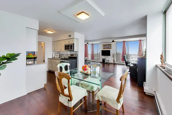 a kitchen with granite countertop a sink stove and refrigerator
