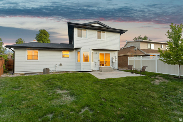 1405 Vintry Lane Murray, UT 84121 - Photo 40 of 44 Rear exterior with light-colored siding and dark roofline