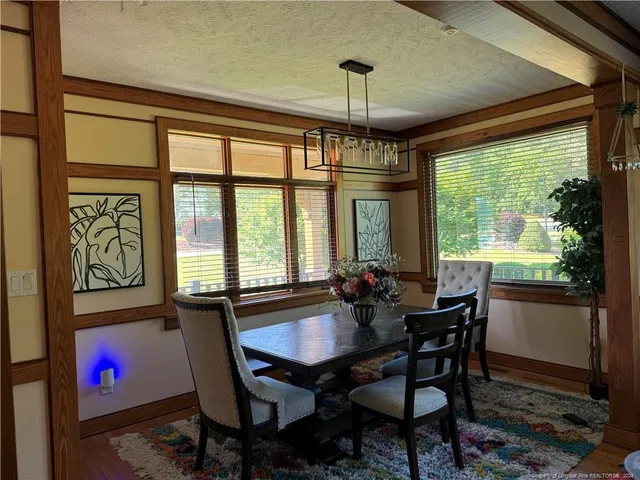 a view of a dining room with furniture window and outside view