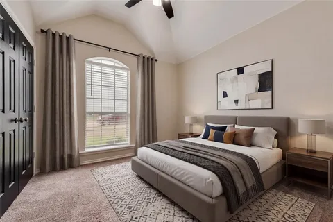 a bedroom with a large bed and a window