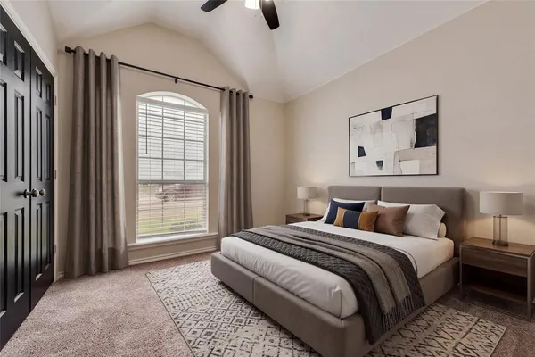 a bedroom with a large bed and a window