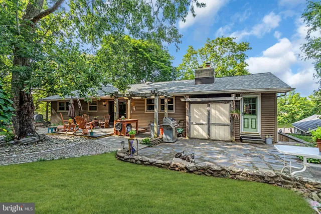 a front view of a house with a garden and patio