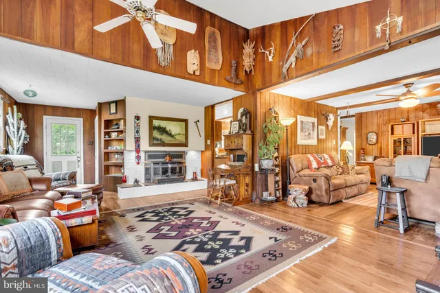 a living room filled with furniture windows and a rug