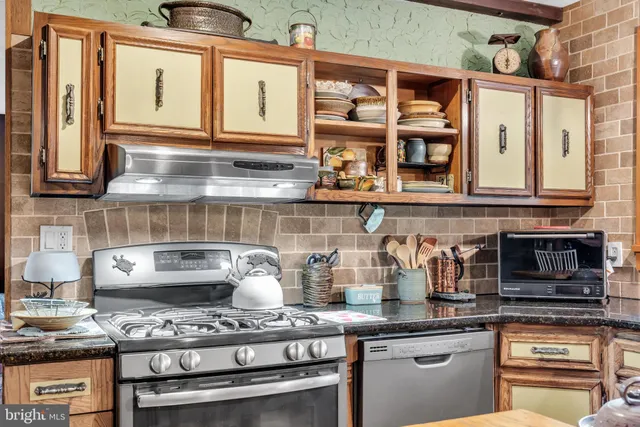 a kitchen with stainless steel appliances granite countertop a stove and a sink