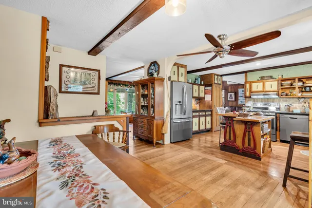 a kitchen with stainless steel appliances granite countertop a refrigerator and a stove