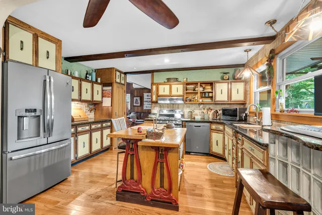a kitchen with stainless steel appliances granite countertop a stove and a sink