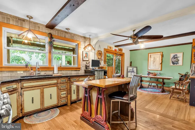 a kitchen with stainless steel appliances granite countertop a sink a stove and a refrigerator