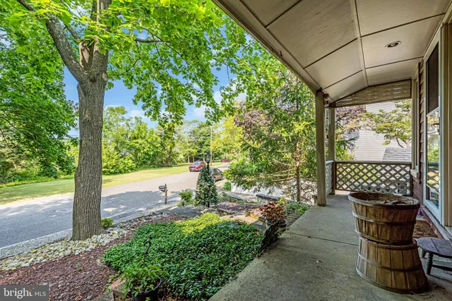a view of a porch with furniture and a yard