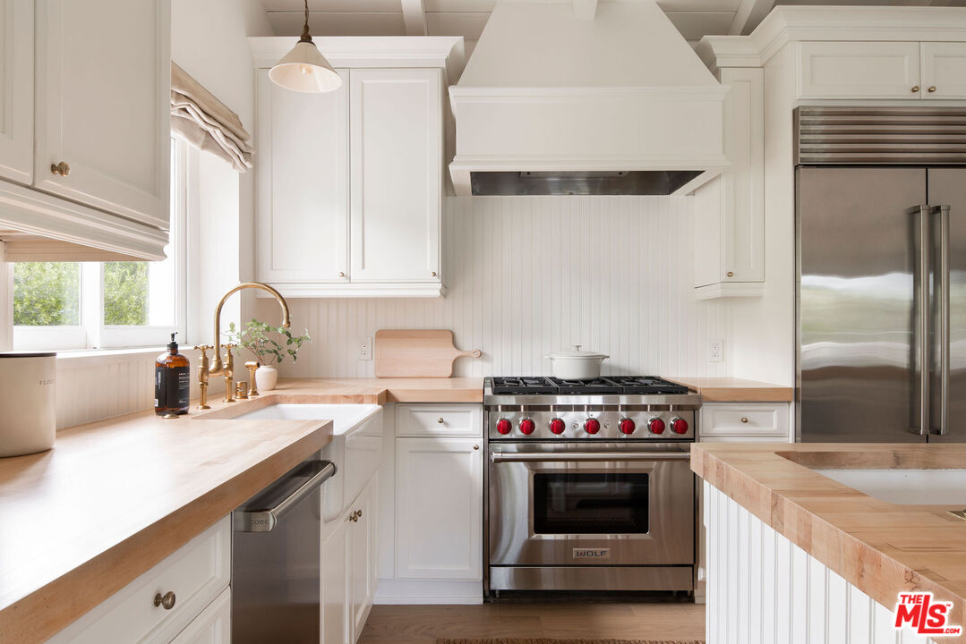 6456 Sycamore Meadows Drive Malibu, CA 90265 - Photo 11 of 34 a kitchen with a stove and a sink
