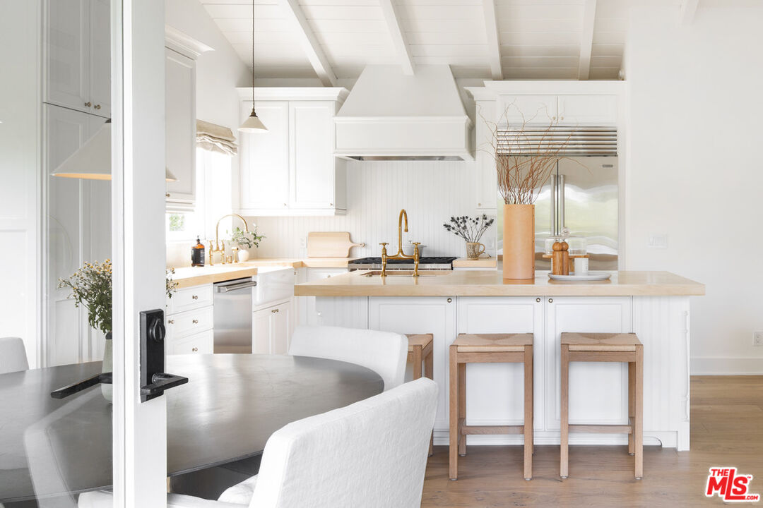 6456 Sycamore Meadows Drive Malibu, CA 90265 - Photo 12 of 34 a kitchen with white cabinets and sink