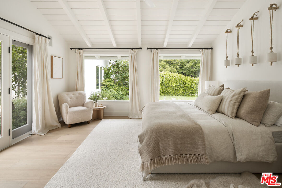 6456 Sycamore Meadows Drive Malibu, CA 90265 - Photo 17 of 34 a bedroom with a bed and a couch next to a window