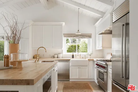 a kitchen with a sink stove and refrigerator