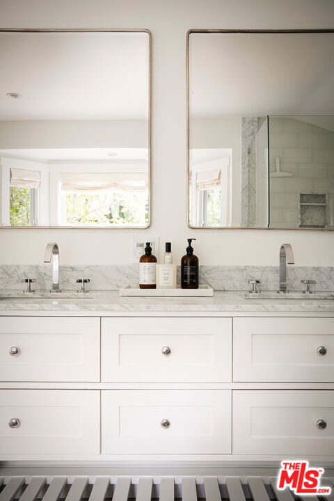 6456 Sycamore Meadows Drive Malibu, CA 90265 - Photo 21 of 34 a bathroom with a sink and a mirror