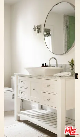 a bathroom with a sink vanity and a mirror