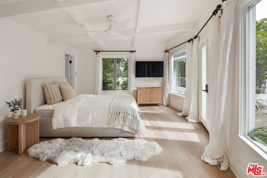 6456 Sycamore Meadows Drive Malibu, CA 90265 - Photo 27 of 34 a bedroom with a large bed and a large window