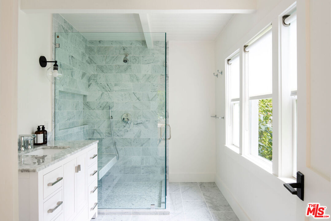 6456 Sycamore Meadows Drive Malibu, CA 90265 - Photo 29 of 34 a bathroom with a shower sink and mirror