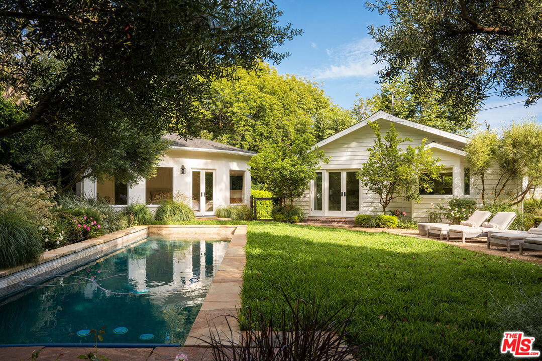 6456 Sycamore Meadows Drive Malibu, CA 90265 - Photo 3 of 34 a front view of a house with a yard table and chairs