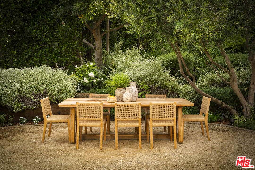 6456 Sycamore Meadows Drive Malibu, CA 90265 - Photo 32 of 34 a view of a dining table and chairs in the patio