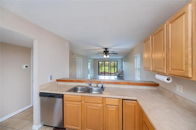 a kitchen with stainless steel appliances granite countertop a sink and a wooden cabinets
