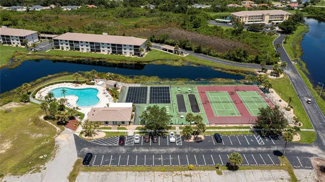 an aerial view of a house with swimming pool and outdoor seating