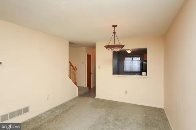 a view of a hallway with a chandelier fan