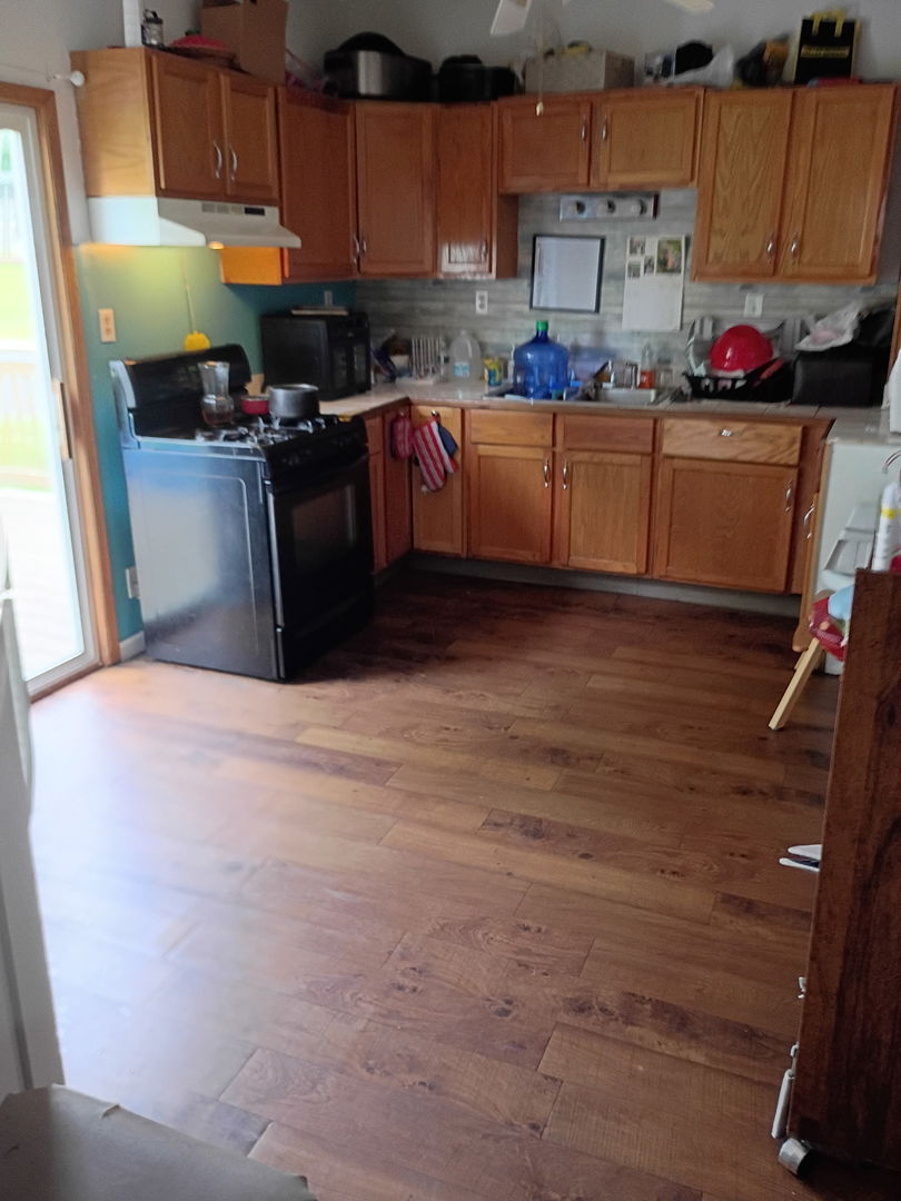 1219 South 7th Street Clinton, IA 52732 - Photo 11 of 15 a kitchen with cabinets and appliances