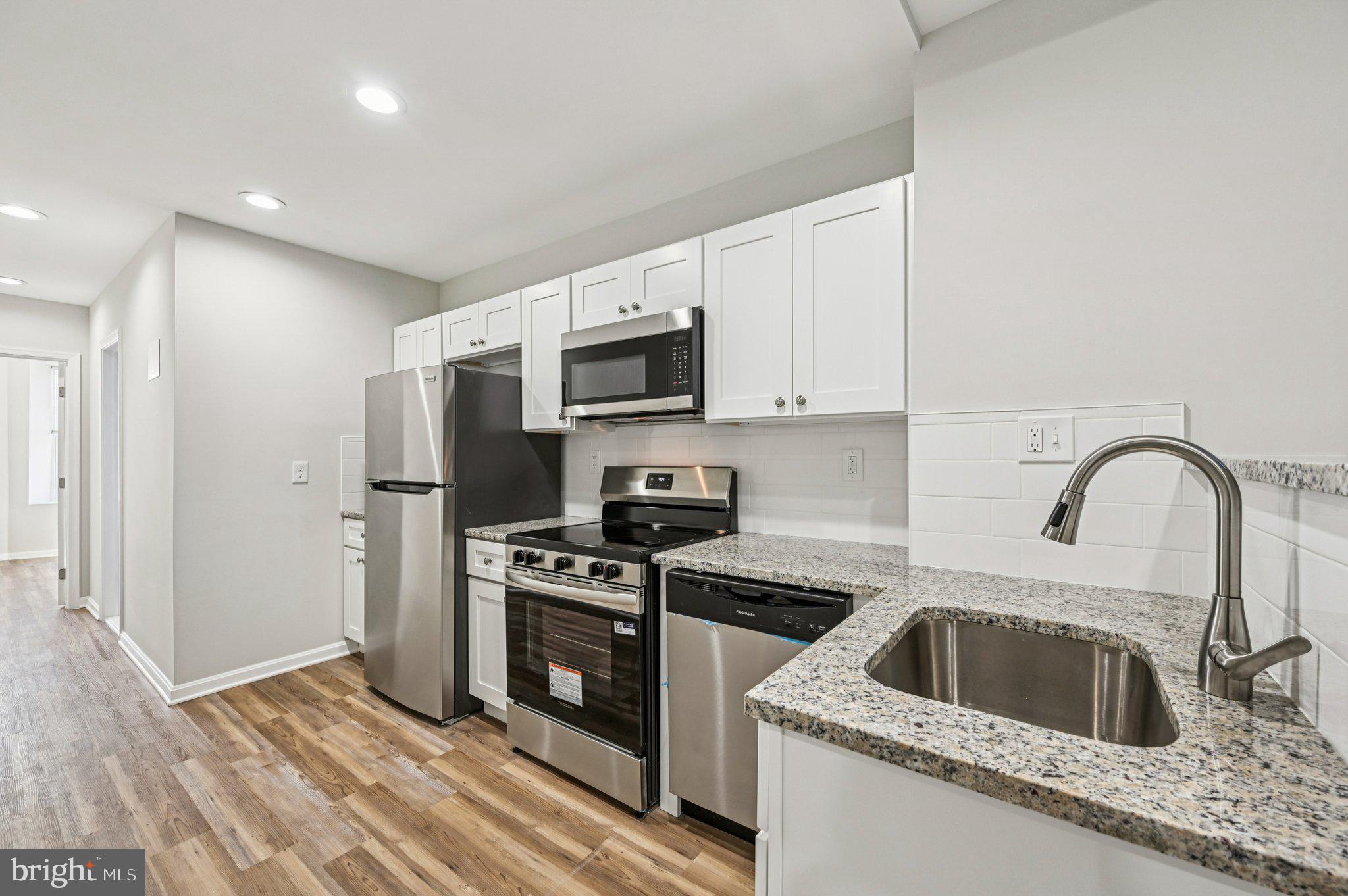 750 Reservoir Street, Unit B Baltimore, MD 21217 - Photo 11 of 25 a kitchen with a sink a stove and refrigerator