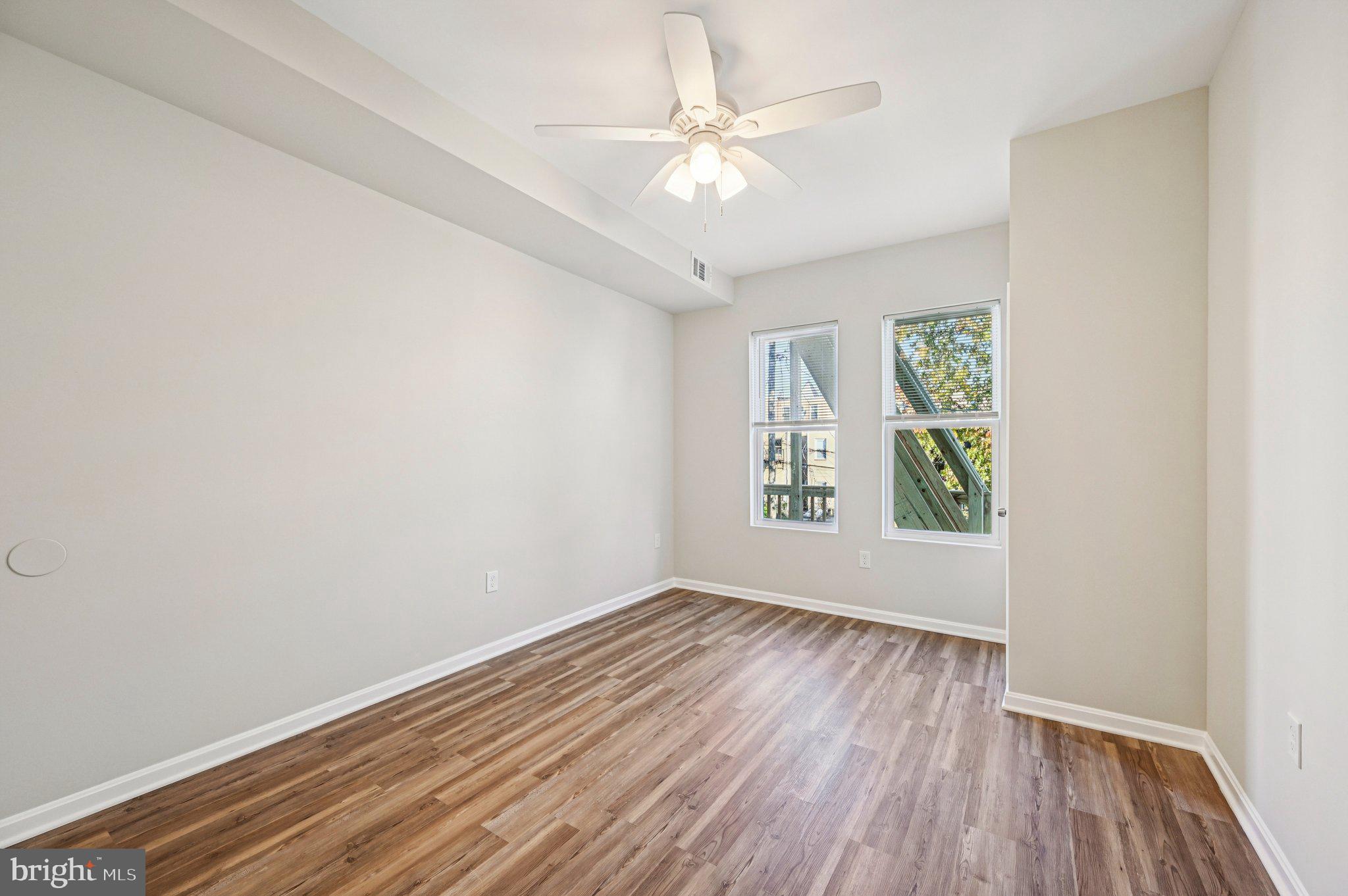750 Reservoir Street, Unit B Baltimore, MD 21217 - Photo 16 of 25 wooden floor in an empty room with a window