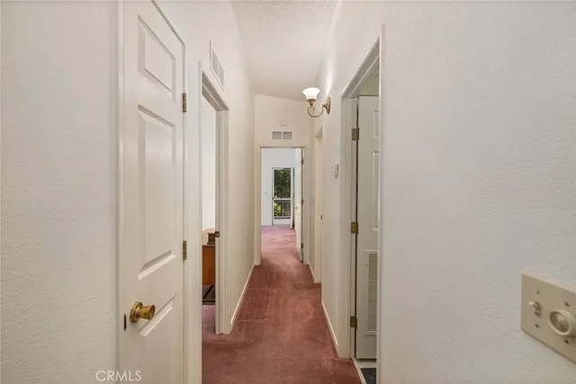a view of a hallway with white walls