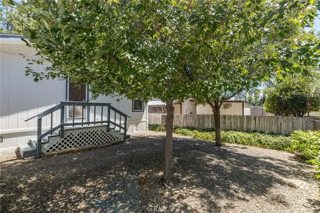 a view of a yard with wooden fence