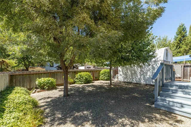 a backyard of a house with plants and outdoor seating