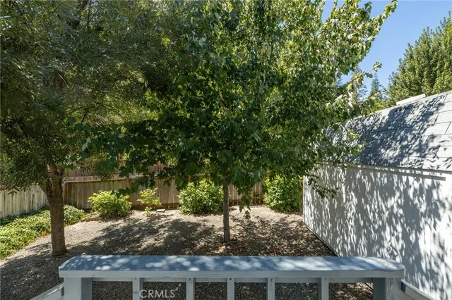 a view of a house with backyard and trees