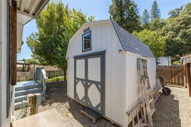 a view of a balcony with wooden floor and iron fence