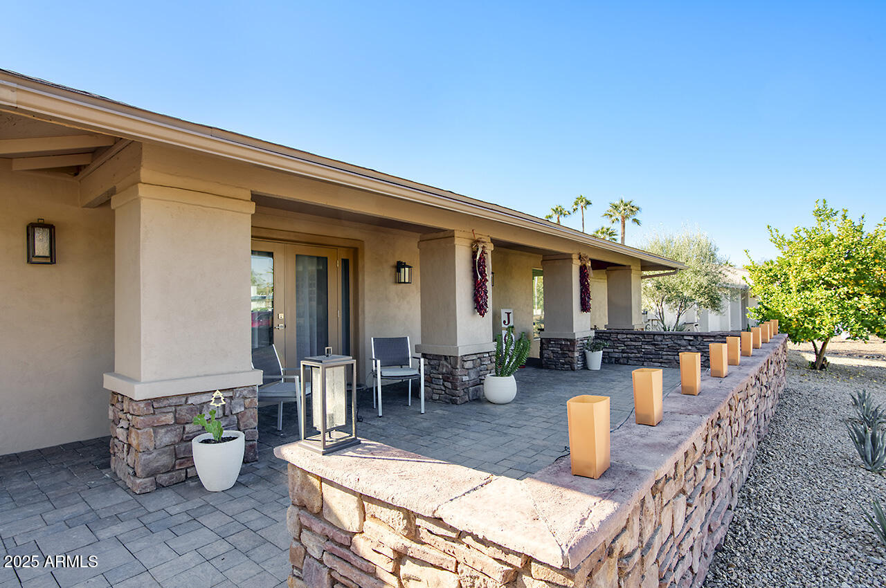 3337 East Las Rocas Drive Phoenix, AZ 85028 - Photo 3 of 22 a view of a patio with dining table and chairs potted plants