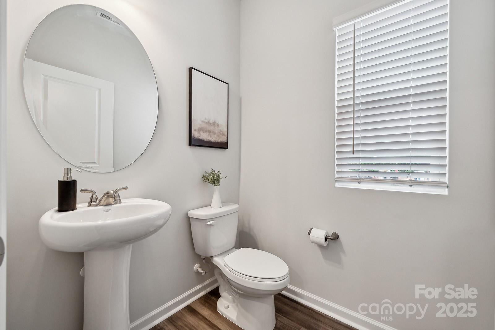 4738 Lakeview Road, Unit 16 Charlotte, NC 28216 - Photo 15 of 24 a bathroom with a toilet sink and mirror