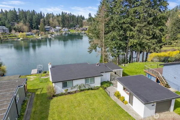 a aerial view of a house with swimming pool and a yard