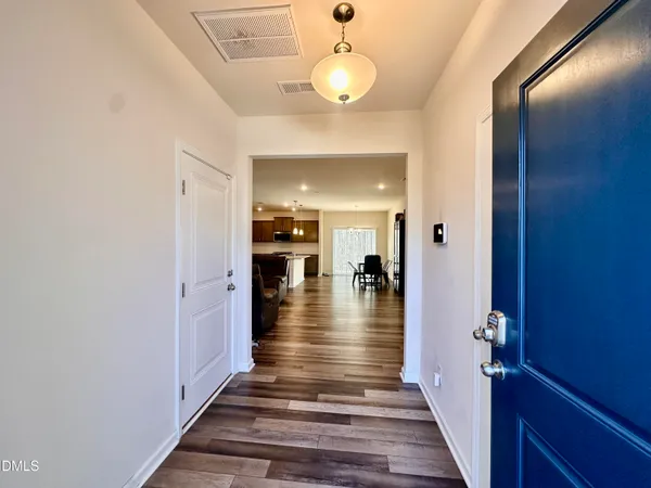 a view of a hallway view with wooden floor and staircase