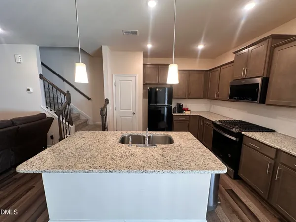 a kitchen with granite countertop a counter top space appliances and cabinets