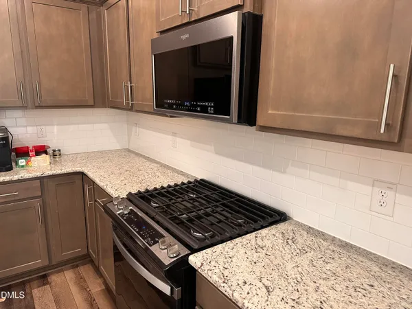 a stove top oven sitting inside of a kitchen